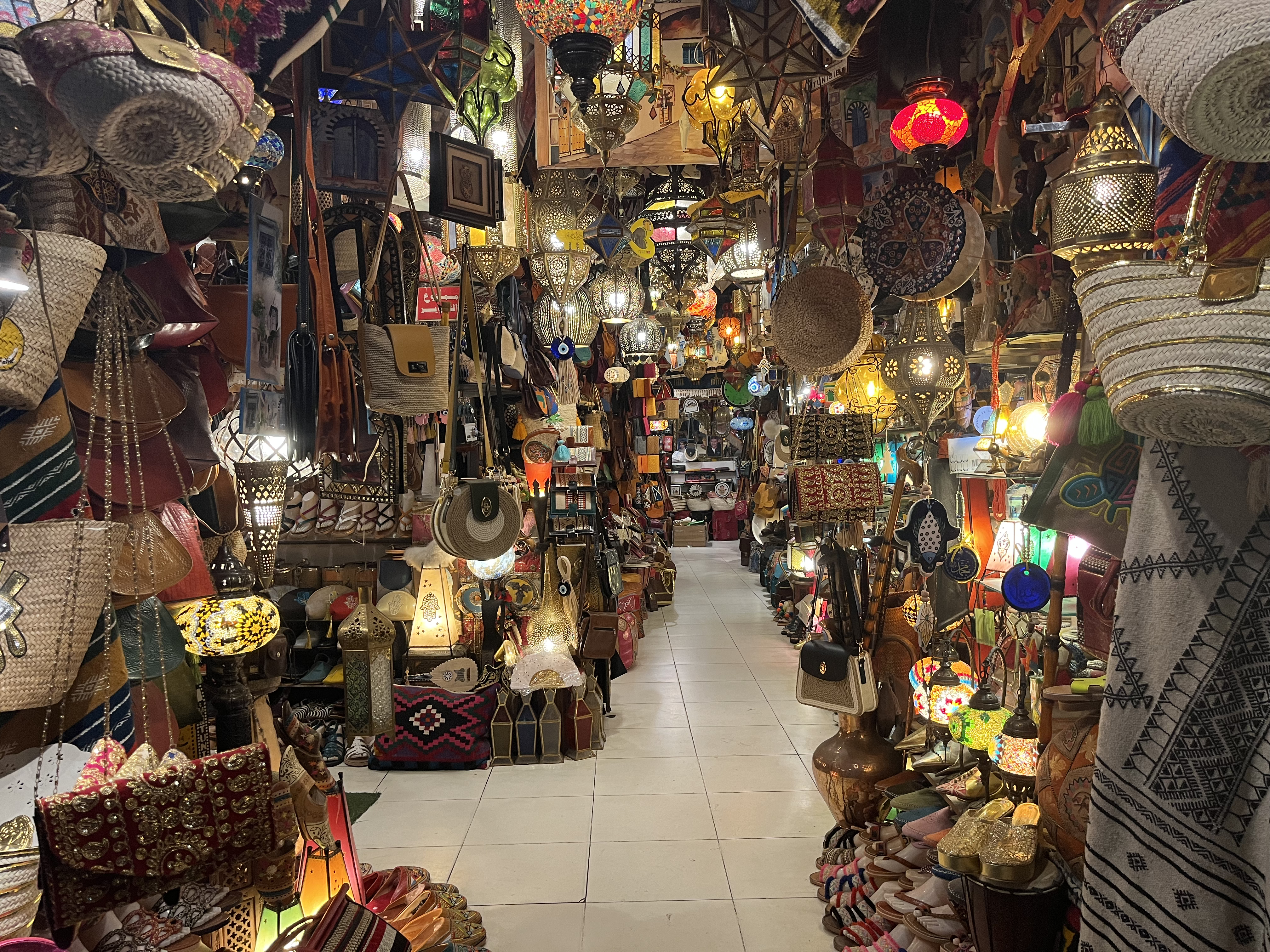 a crowded shop with lights and baskets